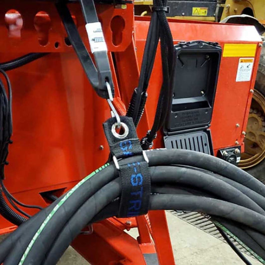 Outback Wrap Bat Wrap being used to lift multiple hydraulic lines so they don't hang and drag.