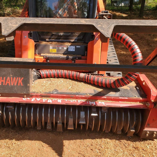 A red Outback Wrap Hose Honcho used to bundle hoses, displayed on forestry equipment.