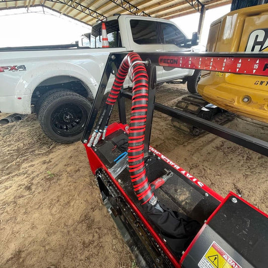 A red Outback Wrap Hose Boss bundline 3 hoses on a Fecon forestry mulcher.