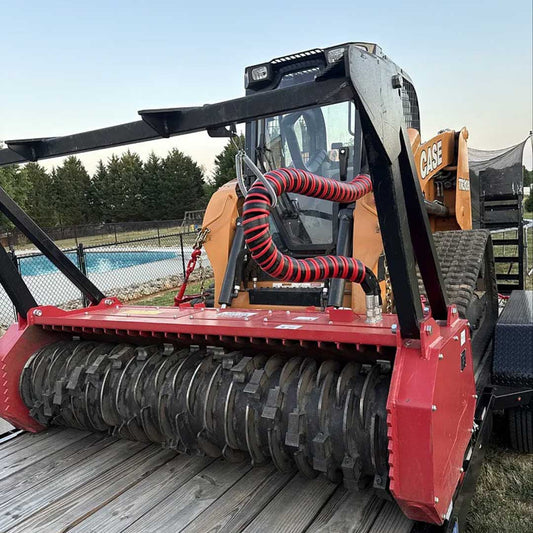 A red Outback Wrap Hose Honcho on a CASE skid steer with an implement