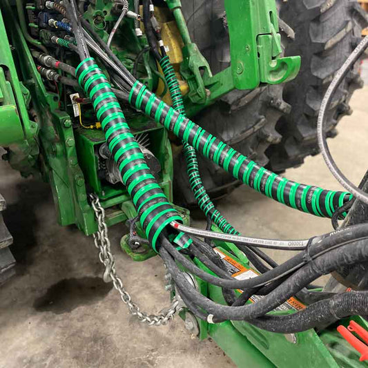Green hose boss spiral wrap on a John Deere Tractor